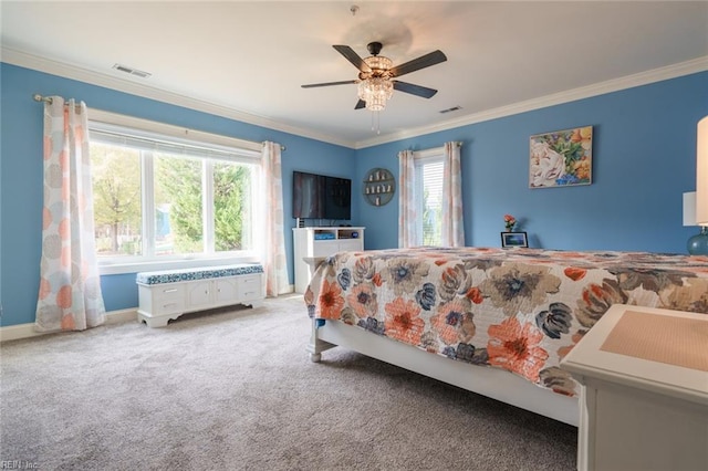 carpeted bedroom with ceiling fan and ornamental molding