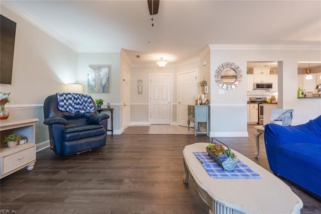 living room with ceiling fan, dark wood-type flooring, and ornamental molding