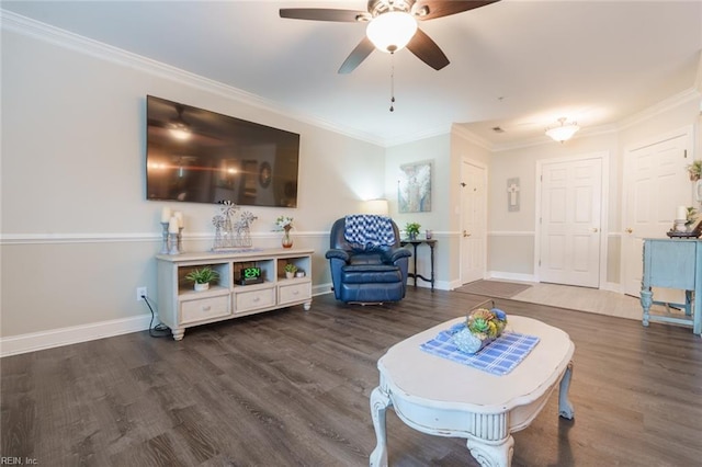 living room featuring dark hardwood / wood-style floors, ceiling fan, and crown molding