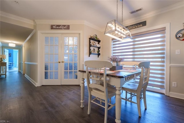 dining area with dark hardwood / wood-style flooring, a wealth of natural light, french doors, and crown molding