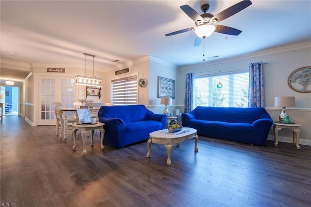 living room featuring dark hardwood / wood-style floors, ceiling fan, and crown molding