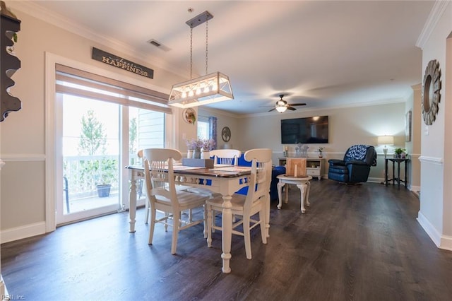 dining room with dark hardwood / wood-style flooring, ceiling fan, and crown molding