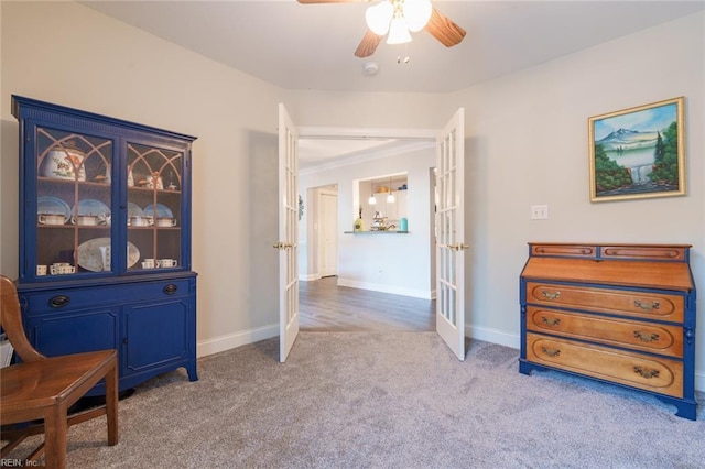 living area with ceiling fan, light carpet, and french doors