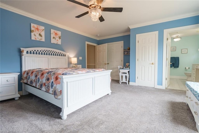 carpeted bedroom with connected bathroom, ceiling fan, and crown molding