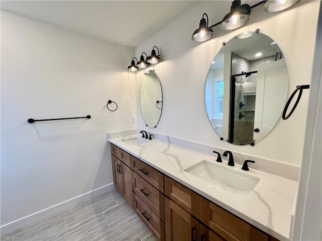 bathroom featuring vanity and a shower with door