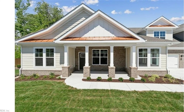 craftsman-style house with covered porch and a front lawn