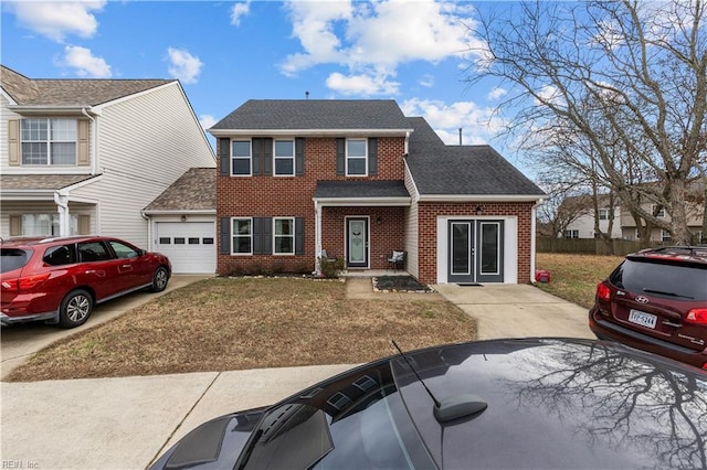 view of front of house featuring french doors, a garage, and a front lawn