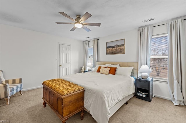 bedroom with ceiling fan and light colored carpet