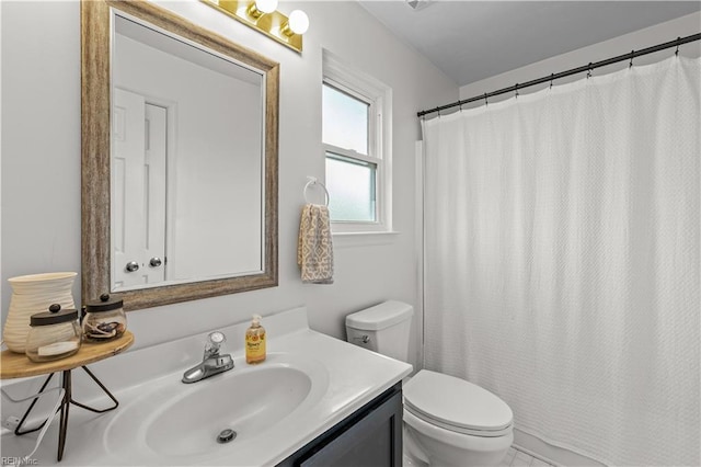 bathroom featuring vanity, toilet, and curtained shower