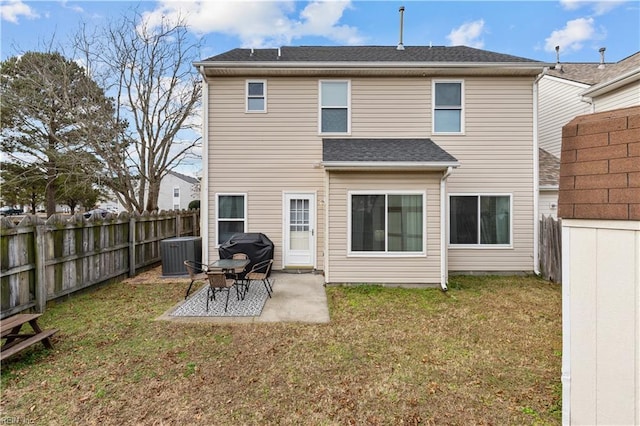 back of property with central AC, a yard, and a patio