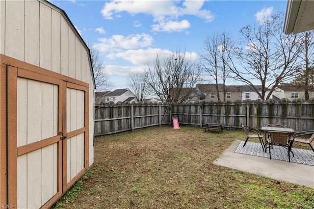 view of yard with a patio area and a storage shed