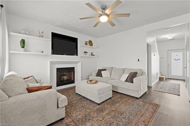 living room with ceiling fan and wood-type flooring