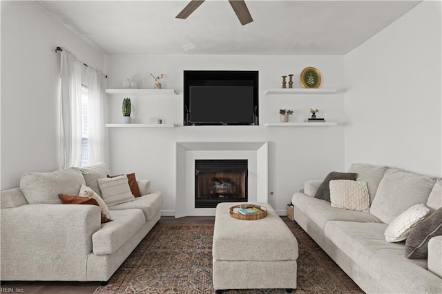 living room featuring ceiling fan and dark wood-type flooring