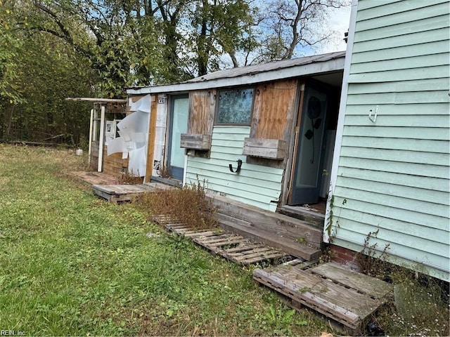 view of side of home with a yard