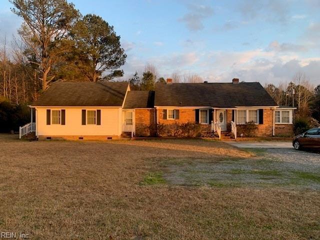 ranch-style home with a front lawn