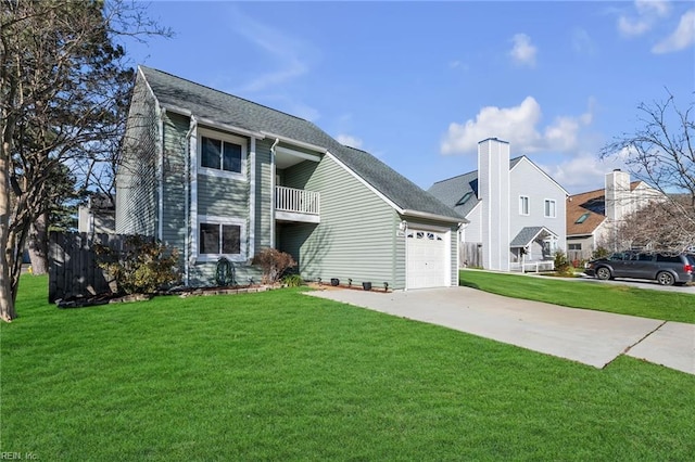 view of front facade featuring a garage, a balcony, and a front yard