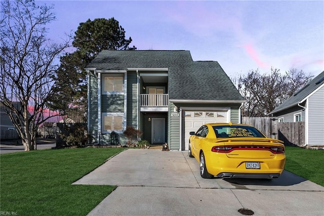 view of front of house featuring a balcony and a yard