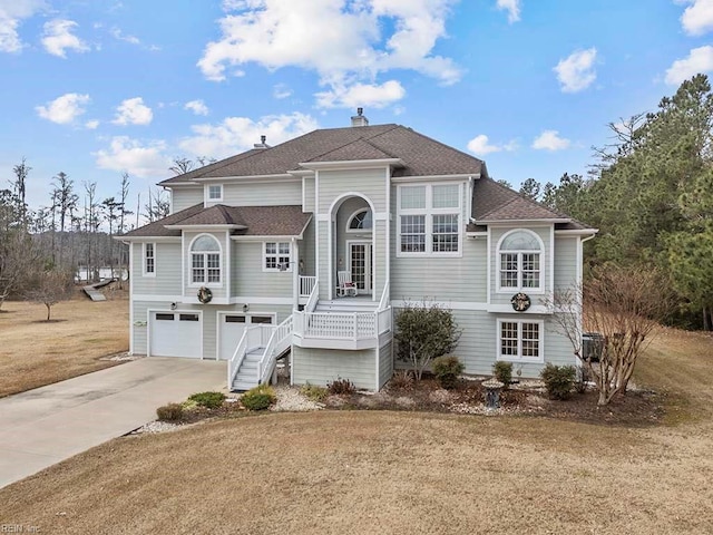 view of front facade with a porch, a garage, a front lawn, and cooling unit