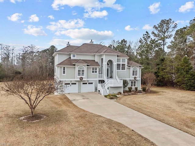 view of front of home with a front lawn and a garage