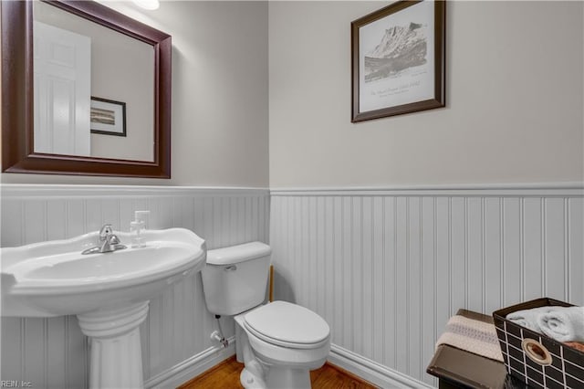 bathroom featuring sink, hardwood / wood-style floors, and toilet