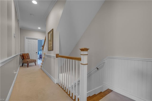 corridor with light colored carpet and crown molding