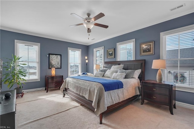 carpeted bedroom featuring multiple windows, ceiling fan, and crown molding