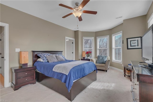 bedroom with ceiling fan and light carpet