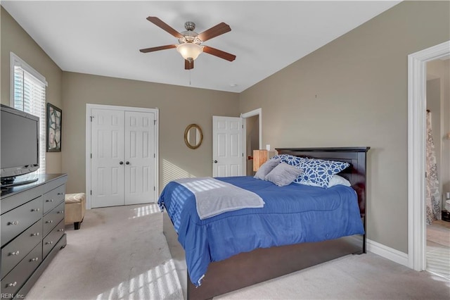 bedroom with a closet, light colored carpet, and ceiling fan