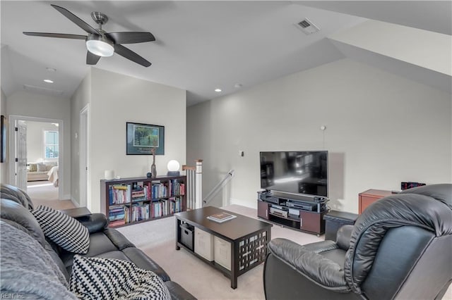 living room featuring ceiling fan, lofted ceiling, and light carpet