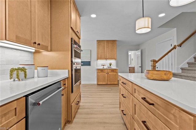 kitchen with pendant lighting, stainless steel appliances, light hardwood / wood-style flooring, and tasteful backsplash