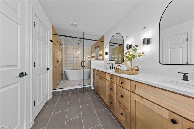 bathroom with plus walk in shower, tile patterned flooring, and vanity