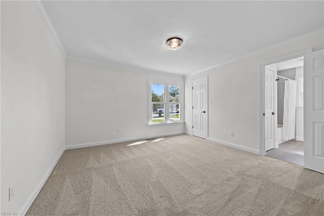 carpeted spare room with crown molding