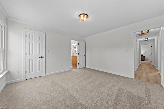 unfurnished bedroom with ornamental molding and light carpet