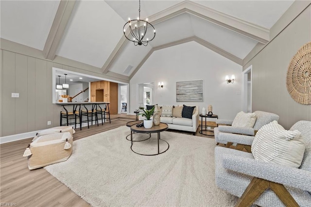 living room featuring beam ceiling, high vaulted ceiling, hardwood / wood-style flooring, and an inviting chandelier