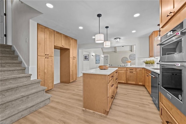 kitchen with pendant lighting, light hardwood / wood-style floors, light brown cabinetry, double oven, and a kitchen island