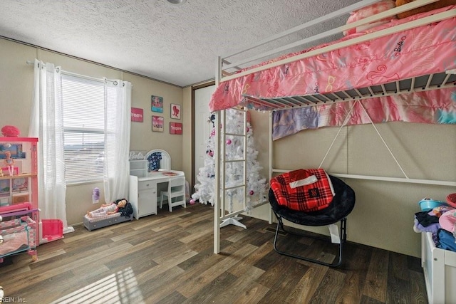 bedroom featuring hardwood / wood-style floors and a textured ceiling