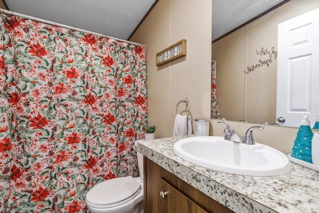 bathroom with ornamental molding, a textured ceiling, vanity, toilet, and curtained shower