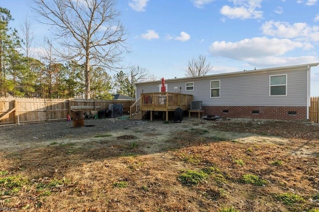 rear view of house featuring central air condition unit and a wooden deck