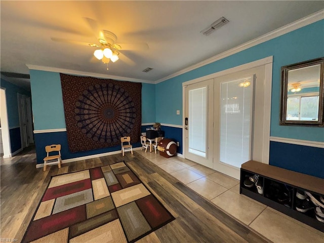 interior space with french doors, ceiling fan, and ornamental molding