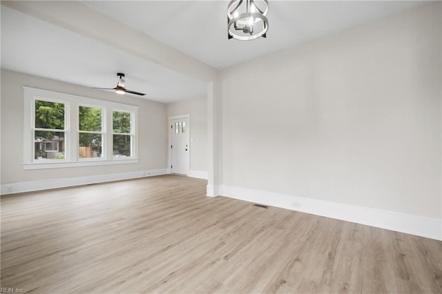 interior space featuring light hardwood / wood-style floors and ceiling fan with notable chandelier