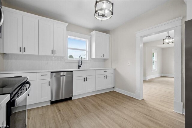 kitchen featuring white cabinets, dishwasher, light wood-type flooring, and decorative backsplash