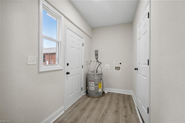 washroom with a wealth of natural light, water heater, hookup for a washing machine, and hookup for an electric dryer