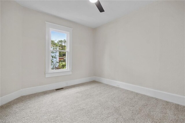 spare room with carpet and ceiling fan