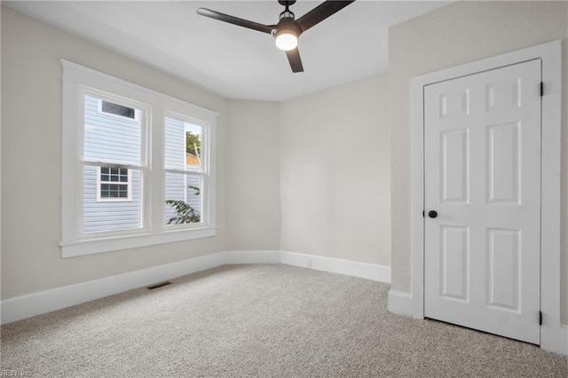 empty room featuring ceiling fan and carpet floors