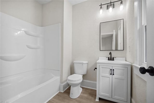 full bathroom featuring hardwood / wood-style floors, vanity, toilet, and shower / bath combination