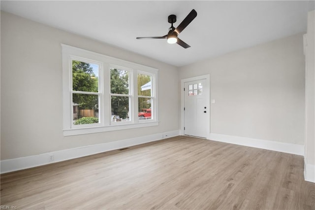 empty room with light hardwood / wood-style floors and ceiling fan