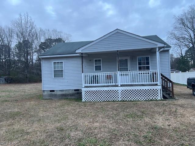 view of front of house with a porch and a front lawn