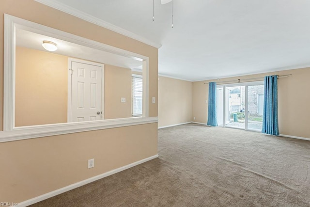 unfurnished room with crown molding and carpet