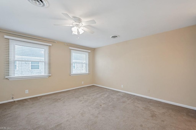 empty room with ceiling fan and light colored carpet