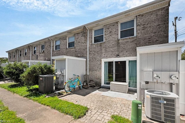 rear view of house featuring a patio and central air condition unit